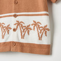 Knitted cardigan with palm tree pattern on a white background