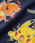 Close-up of a navy kids' t-shirt print showing a fiery orange cartoon creature and a yellow electric cartoon character with lightning bolt effects