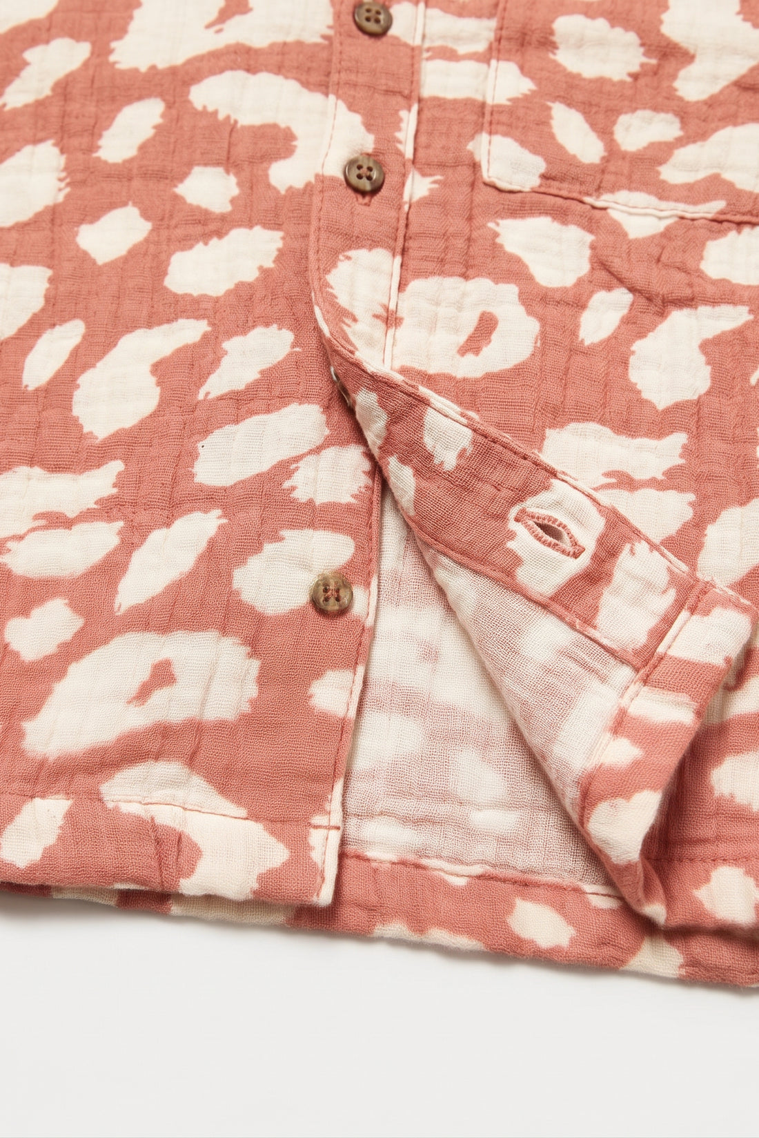Coral pink kids short sleeve shirt with cream animal print, camp collar, button front and chest pocket