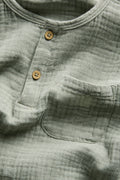PTex Fashion sage green muslin shirt, close-up of button placket and chest pocket