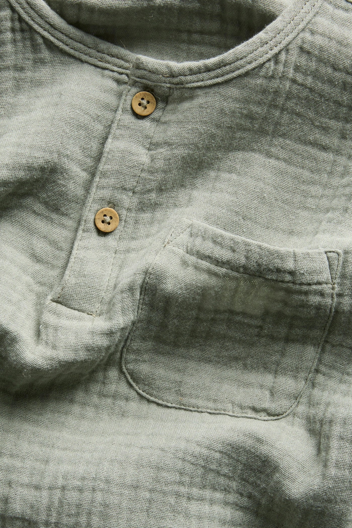 PTex Fashion sage green muslin shirt, close-up of button placket and chest pocket