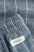 Close-up of ramie cotton weave and elasticated waist on blue striped kids' trousers — PTex Fashion