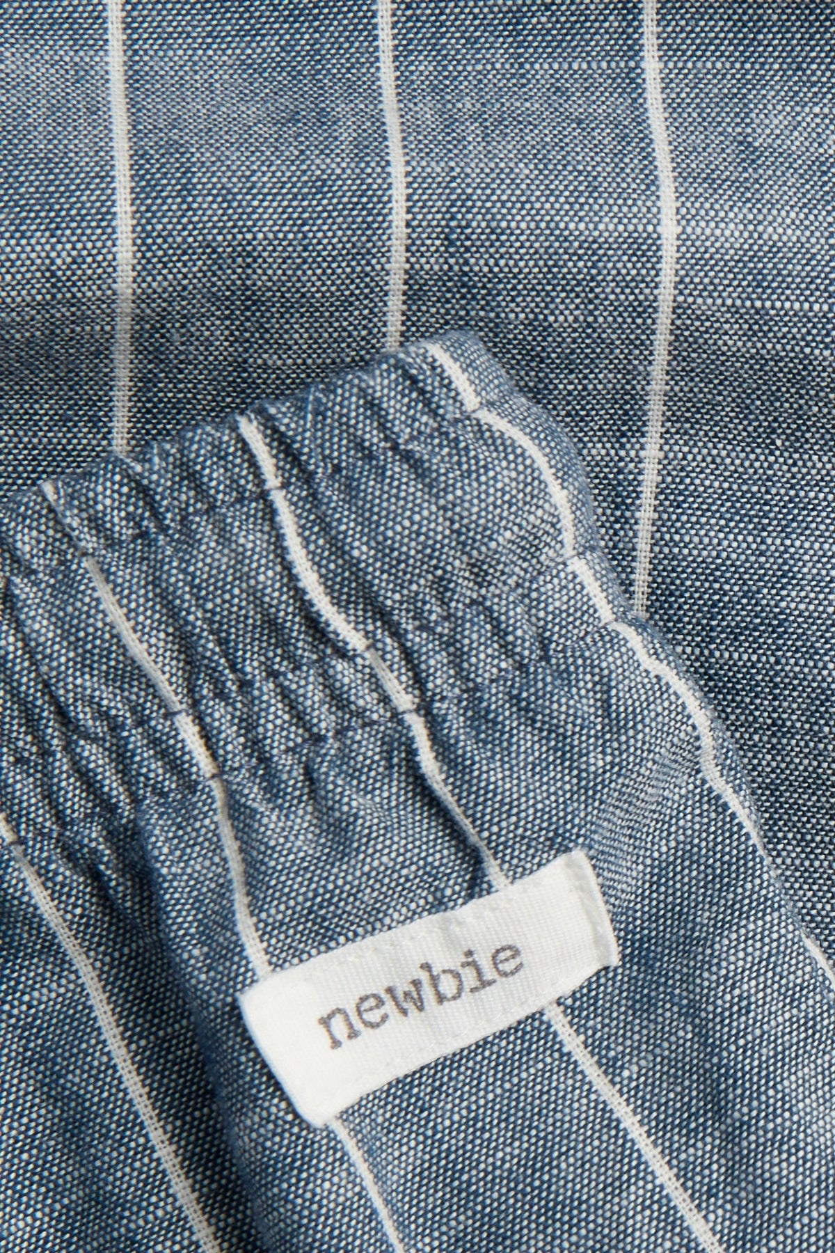 Close-up of ramie cotton weave and elasticated waist on blue striped kids' trousers — PTex Fashion