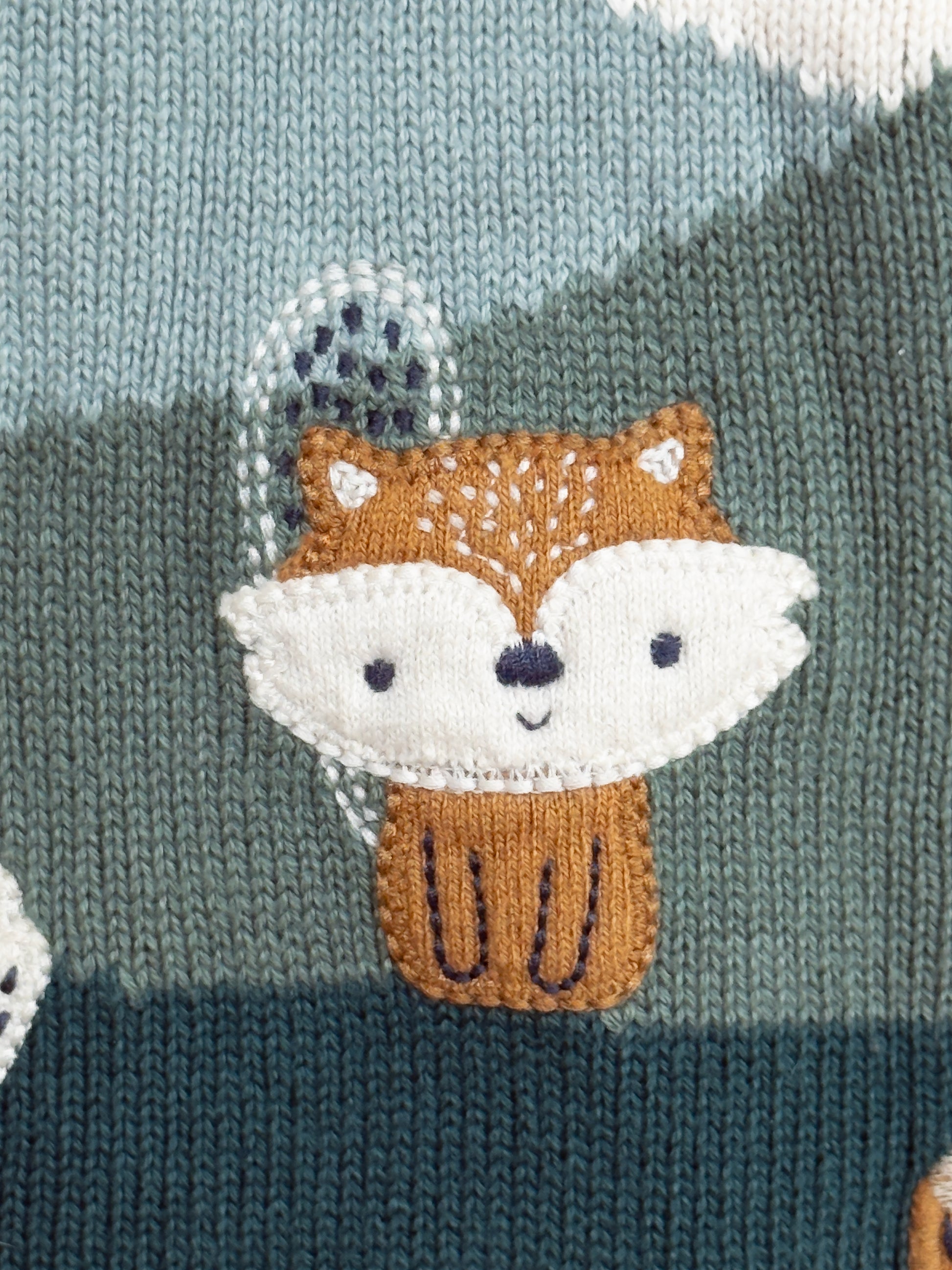 Knitted sweater with a fox design on a knitted background