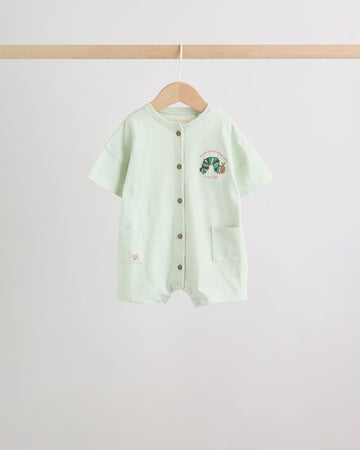 Mint green baby romper front view with caterpillar graphic and wooden button placket on wooden hanger