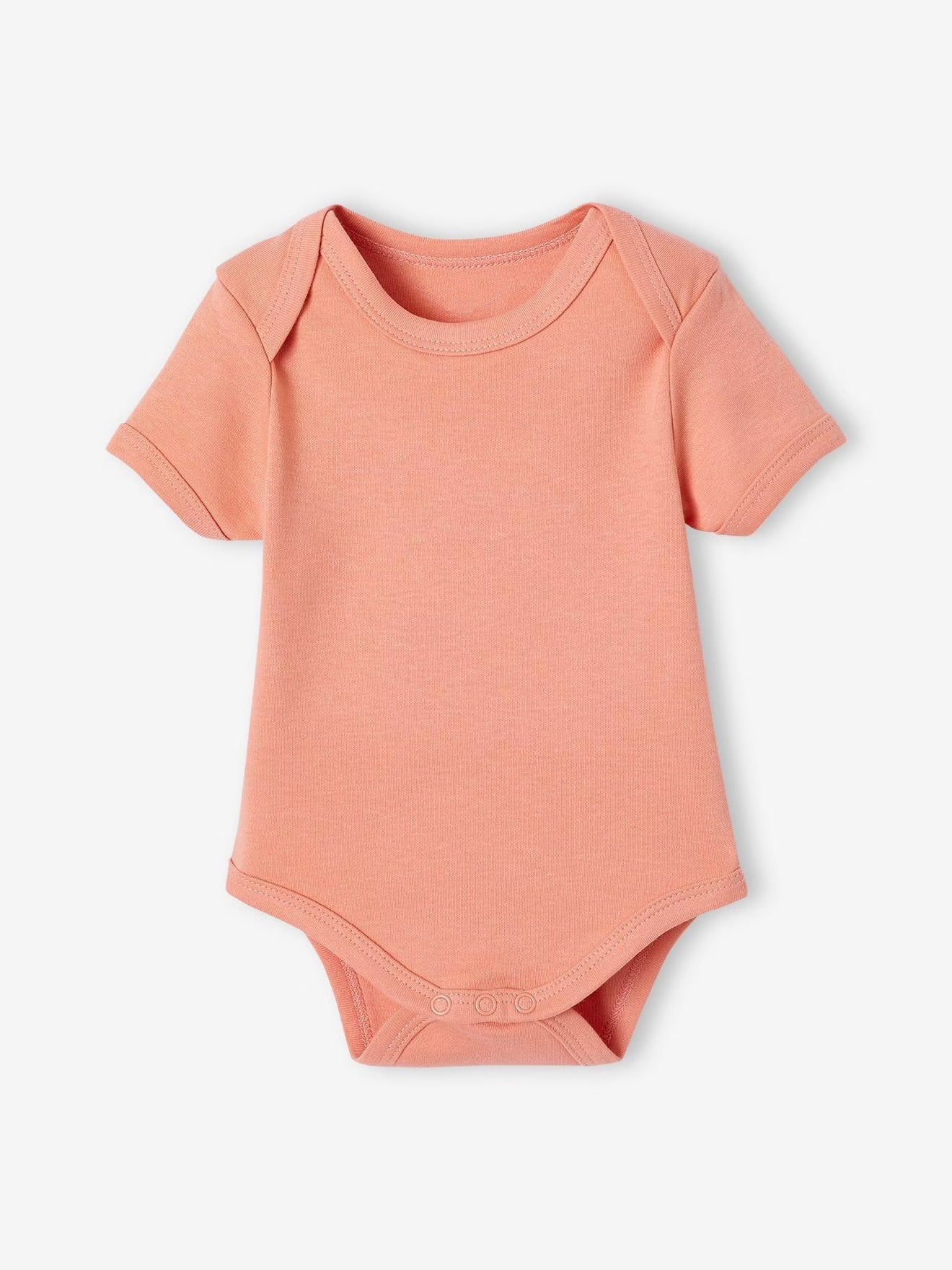 Peach-colored baby bodysuit on a white background