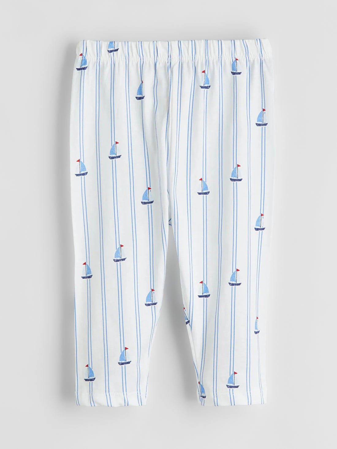 Pajama pants with sailboat pattern on a white background