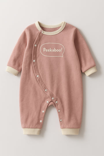 Pink baby onesie with 'Peekaboo!' text on a light gray background