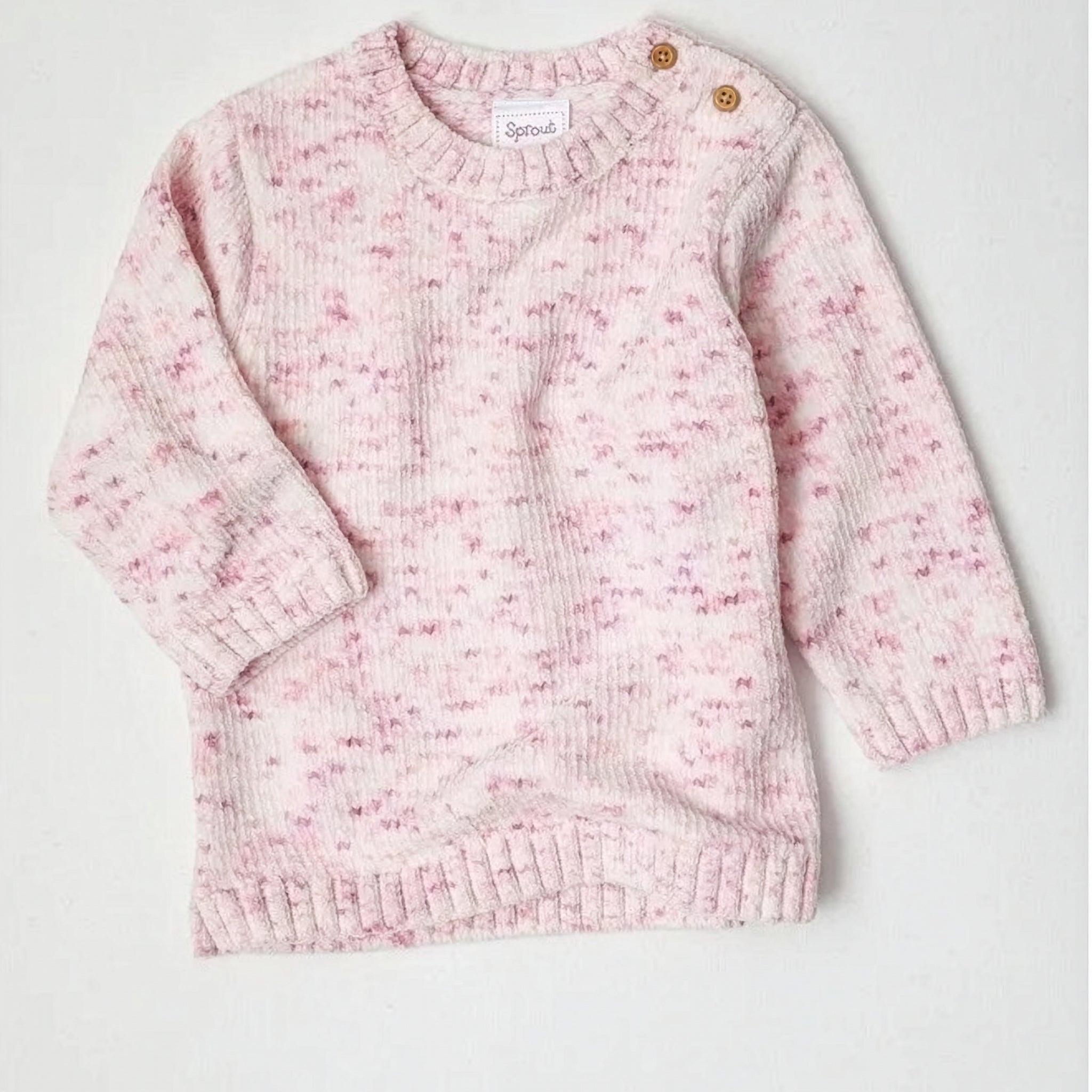 Pink knitted sweater on a white background