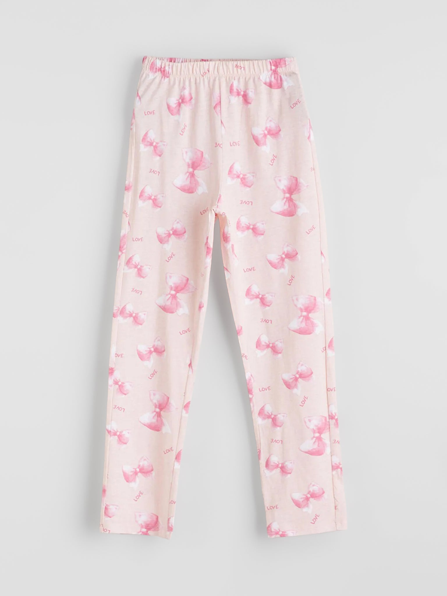 Pink pajama pants with a subtle pattern on a light gray background