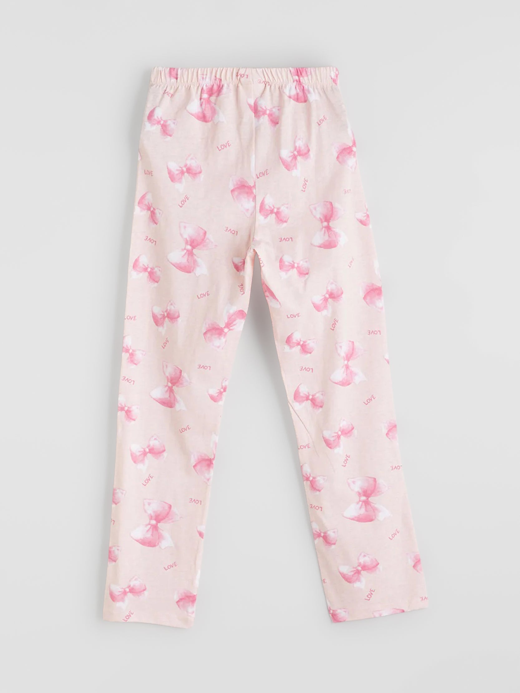 Pink pajama pants with flamingo pattern on a light gray background