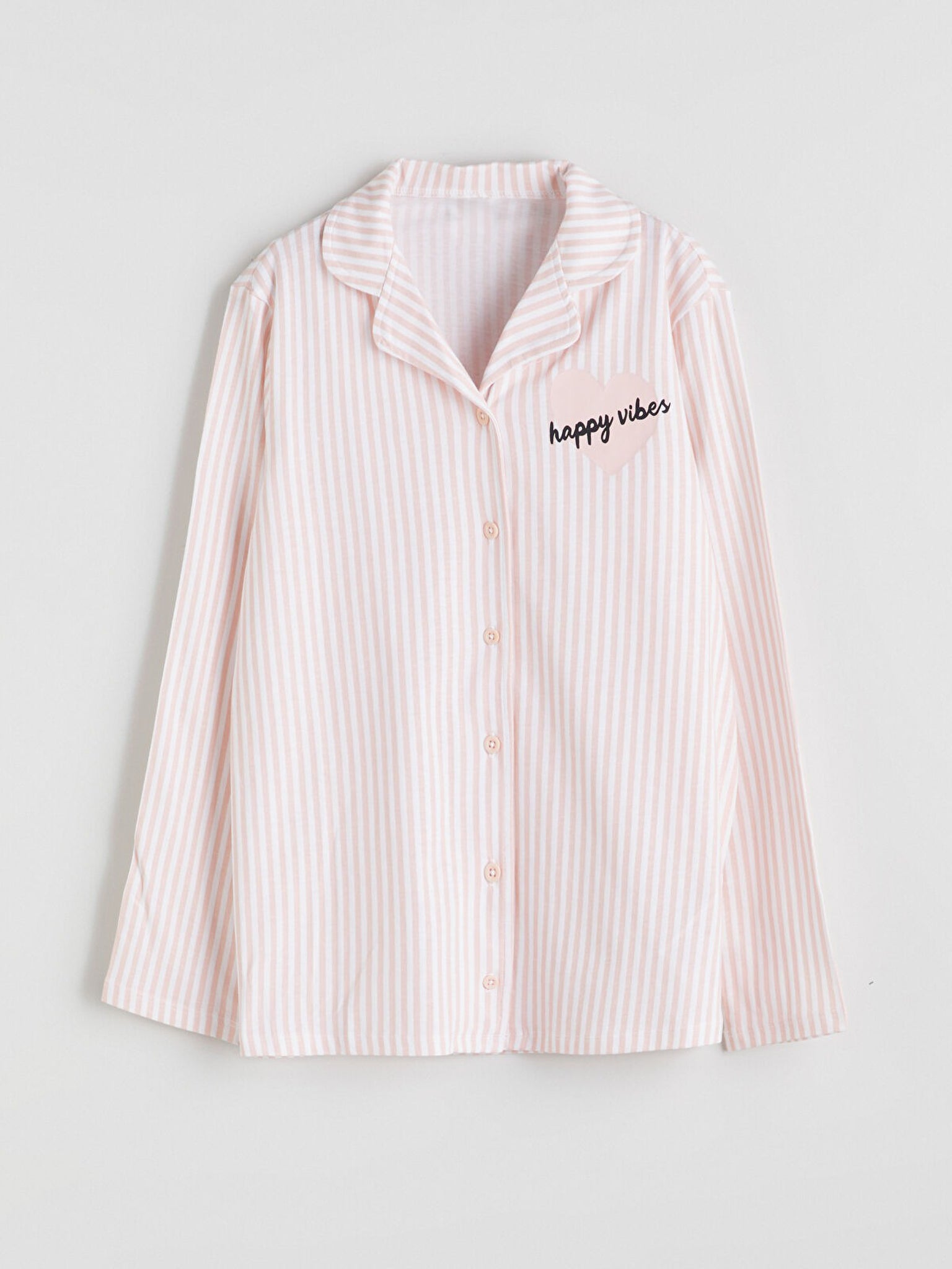 Pink striped shirt with 'happy vibes' text on a light gray background