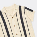 Knitted cardigan with black and white stripes on a light gray background