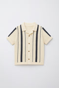 Beige short-sleeve shirt with black stripes on a light gray background