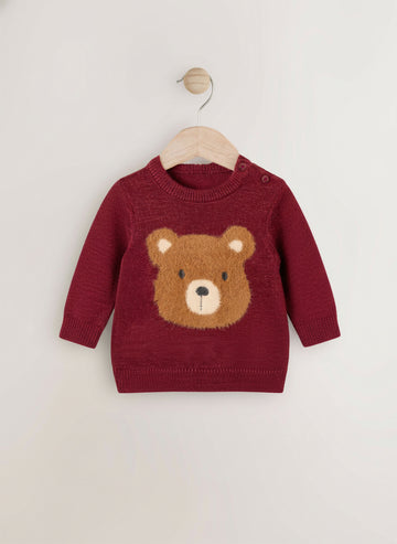 Red sweater with a bear face design on a wooden hanger against a white background