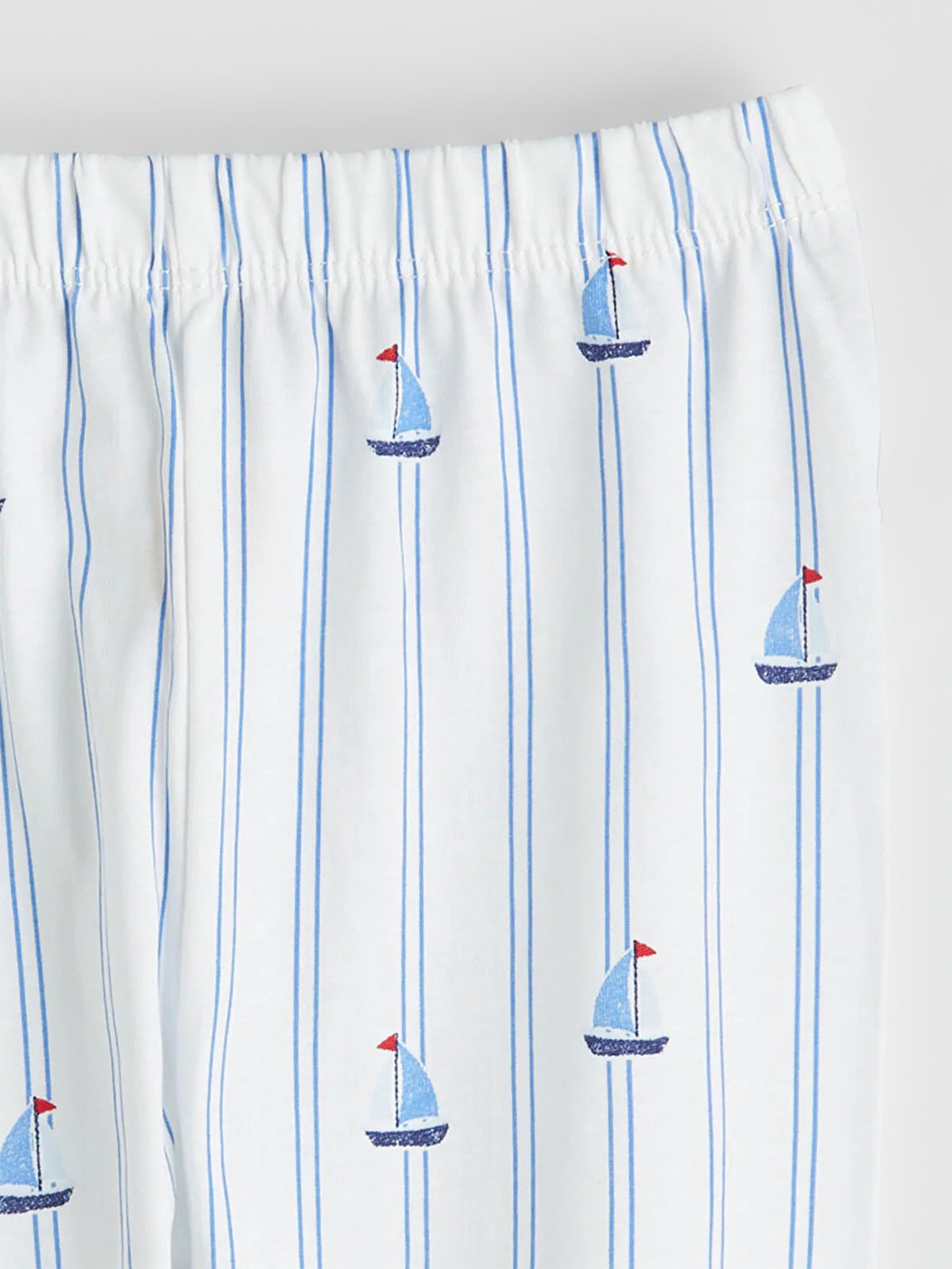 Pajama pants with sailboat pattern on a white background