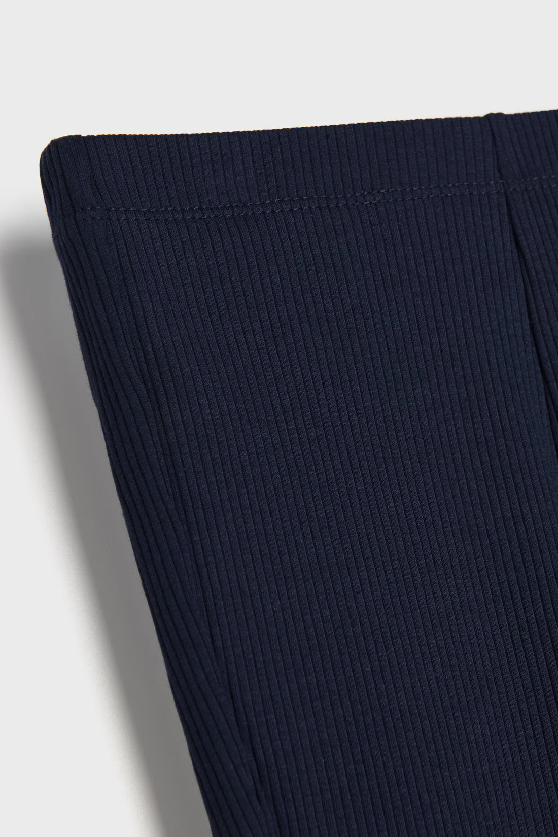Dark navy blue toddler girls ribbed cotton flared leggings with elastic waist and fine ribbed fabric texture.