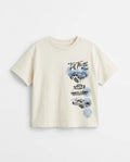  Front flat lay: Front view flat lay of an off-white toddler drop shoulder tee with a vertical stacked 