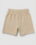 Full front flat-lay view of toddler waffle cotton short pants in warm beige with elasticated waistband and relaxed short-length silhouette on a light grey background.