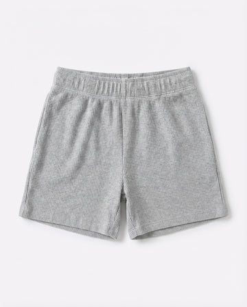 Full front flat-lay view of toddler waffle cotton short pants in light grey with elasticated waistband and relaxed short-length silhouette on white background.