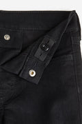 Close-up of a black jacket with buttons on a white background
