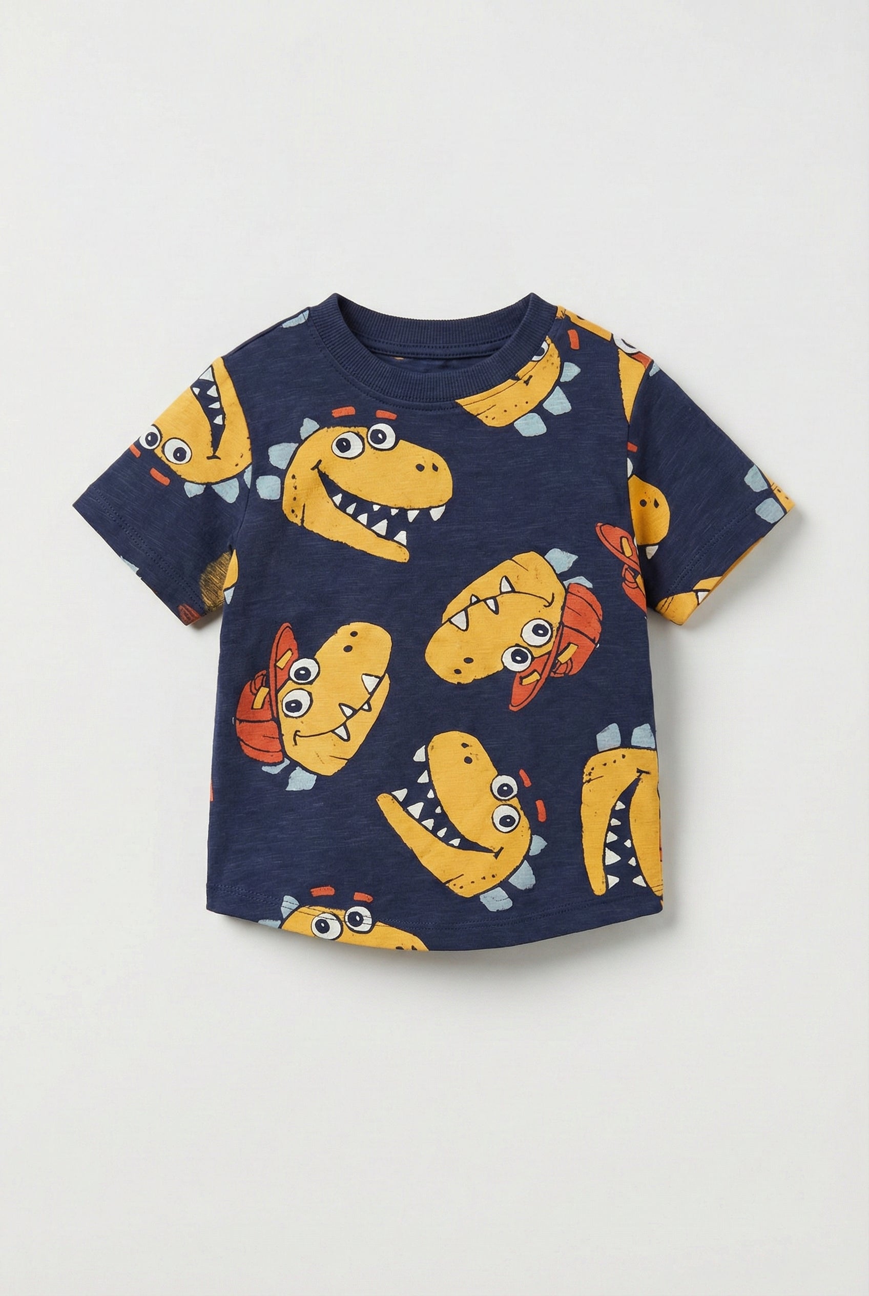 Navy blue t-shirt with yellow dinosaur prints on a light gray background