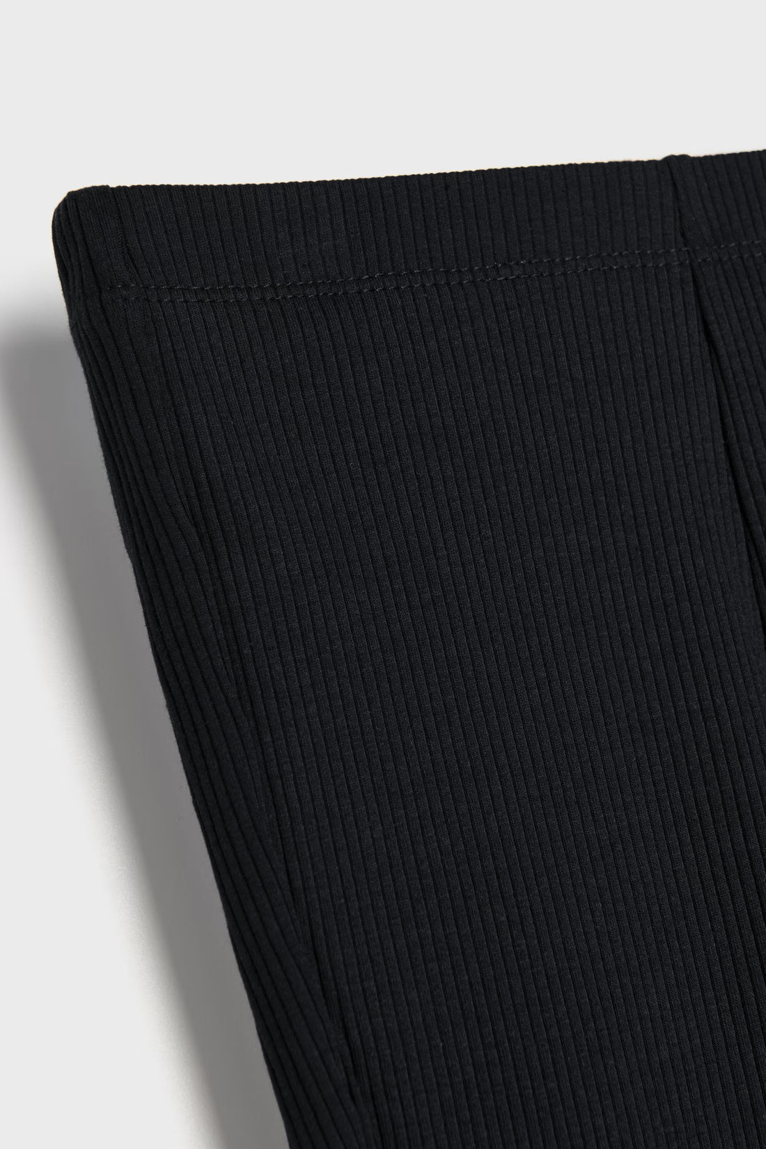 Black toddler girls ribbed cotton flared leggings with elastic waistband and soft textured rib fabric.