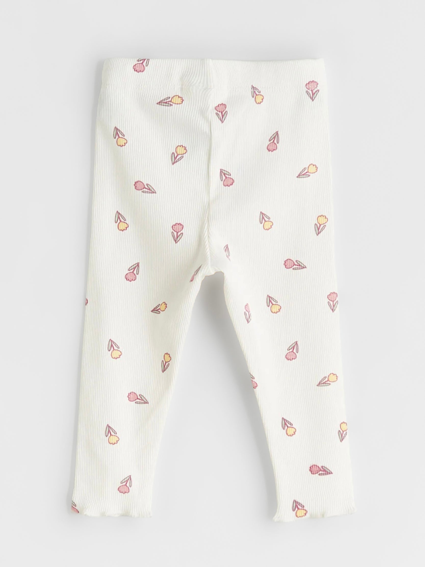 White baby leggings with tulip pattern on a white background