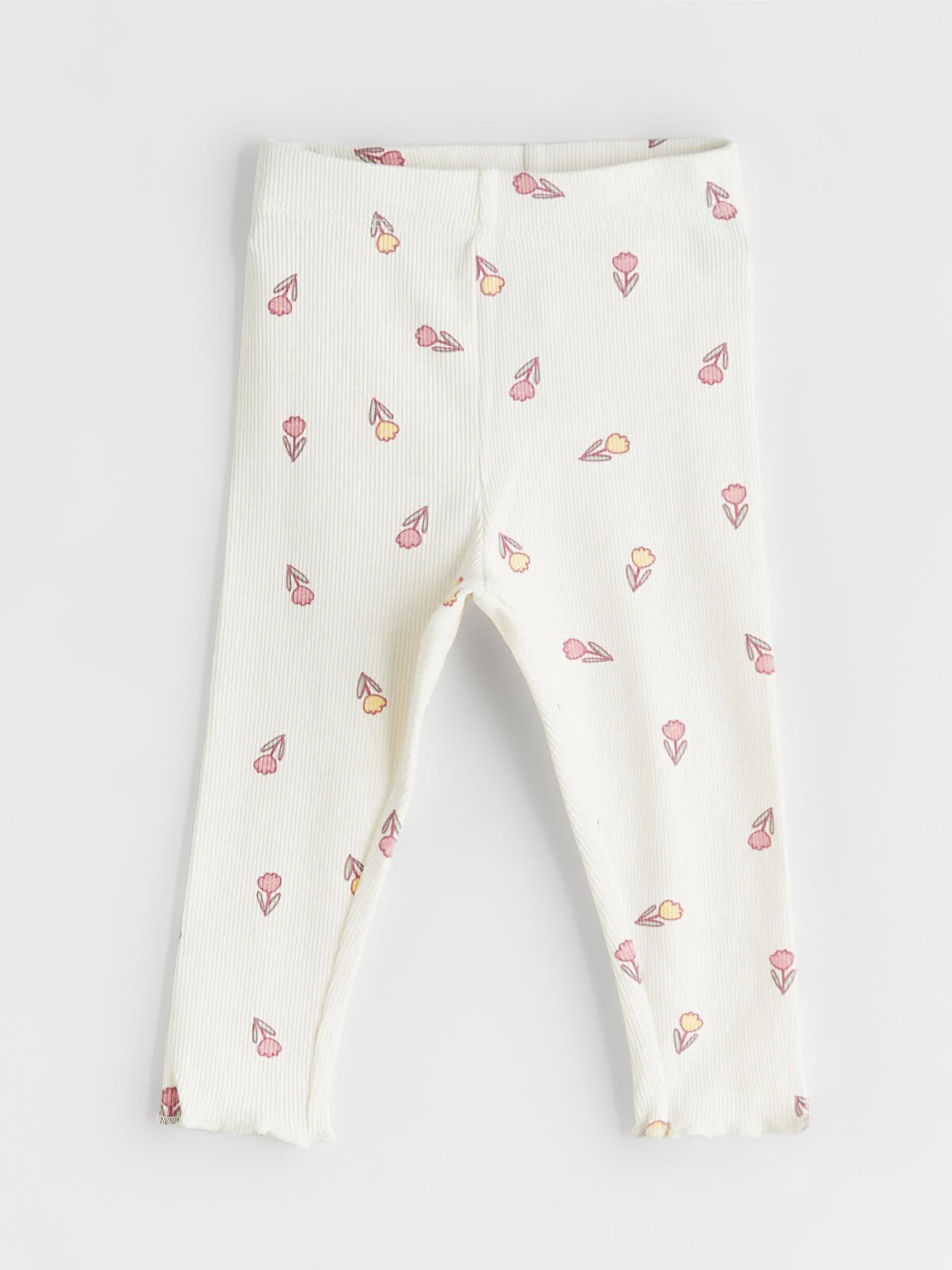White leggings with small colorful patterns on a light gray background