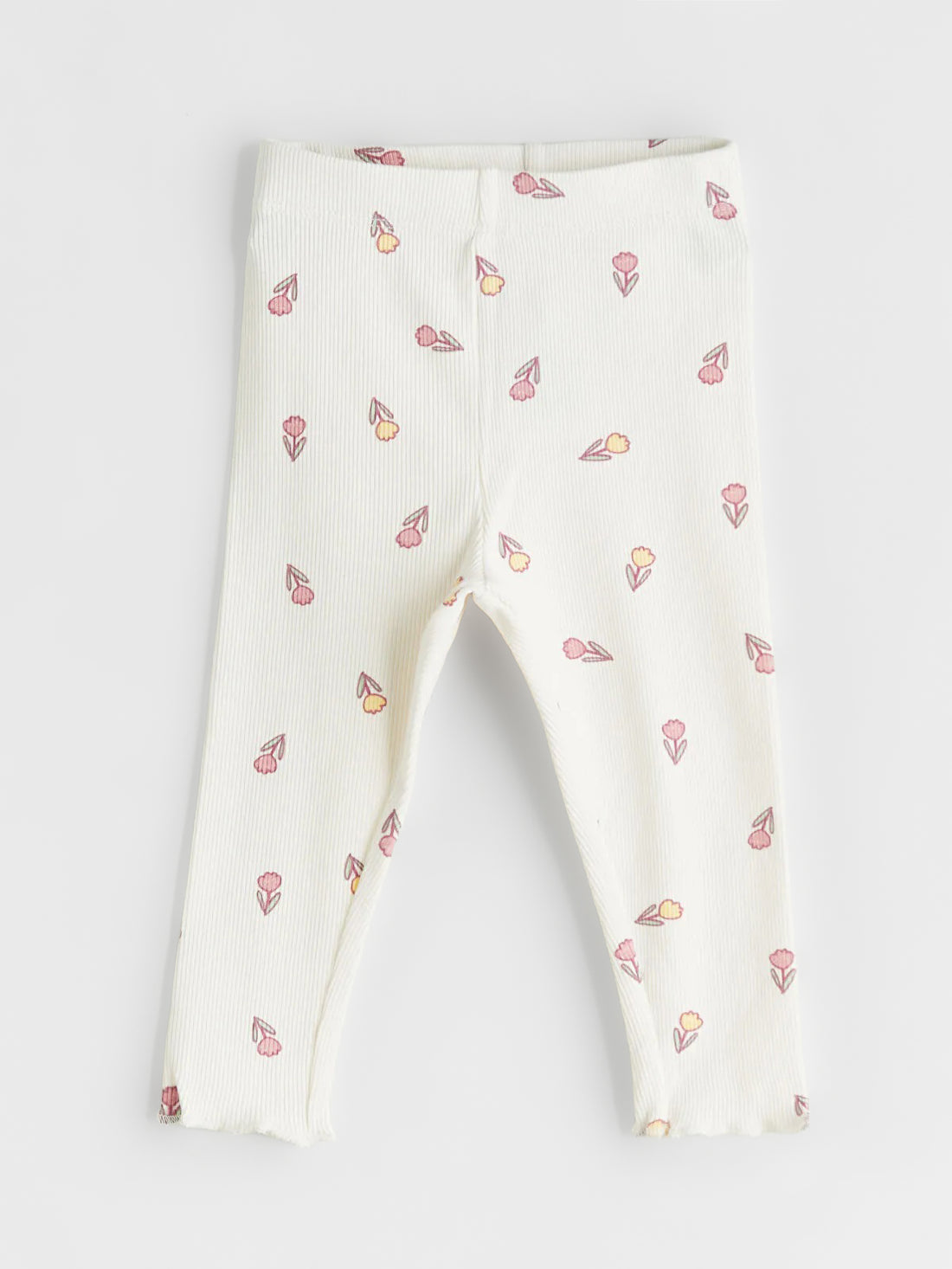 White leggings with small colorful patterns on a light gray background