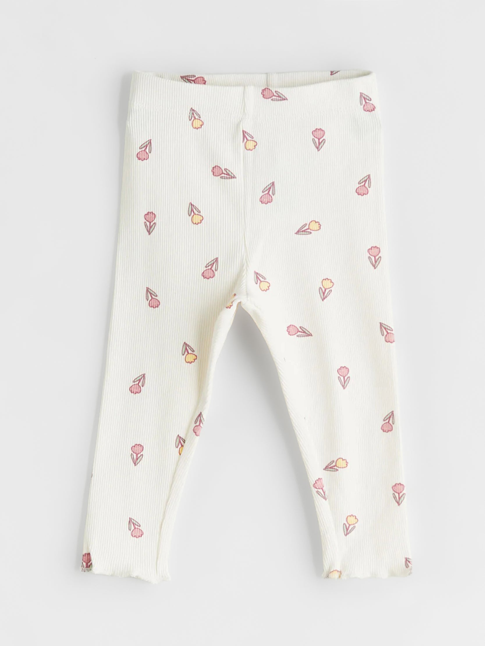 White leggings with small colorful patterns on a light gray background