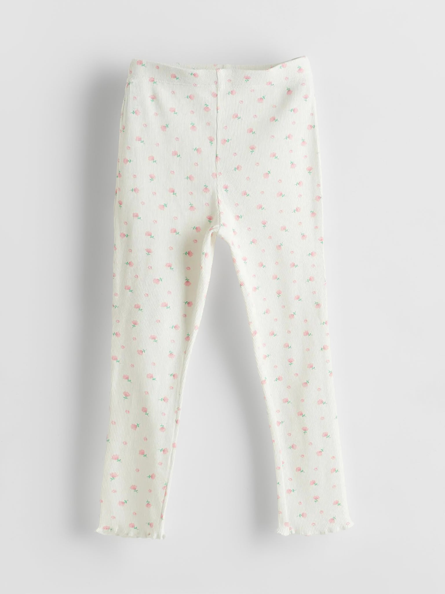 White leggings with small pink patterns on a light gray background