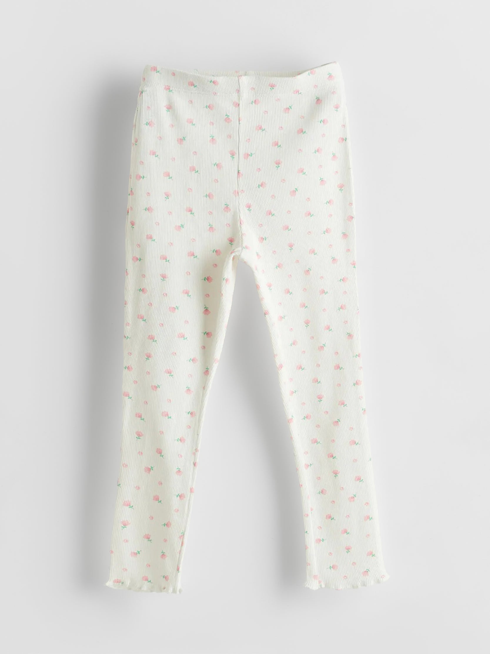 White leggings with small pink patterns on a light gray background