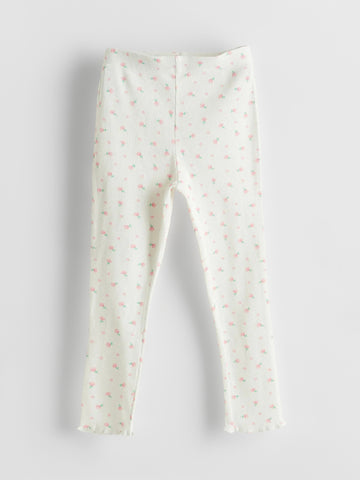 White leggings with small pink patterns on a light gray background