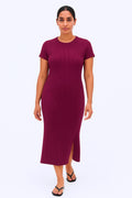 Woman wearing a burgundy dress on a white background