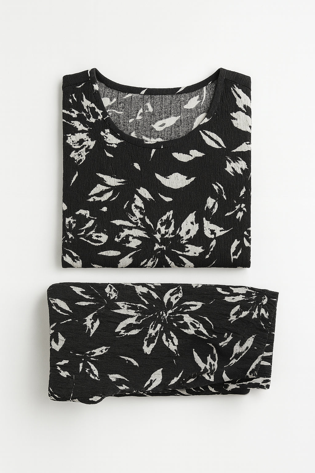 Black and white floral-patterned top and bottom set on a white background