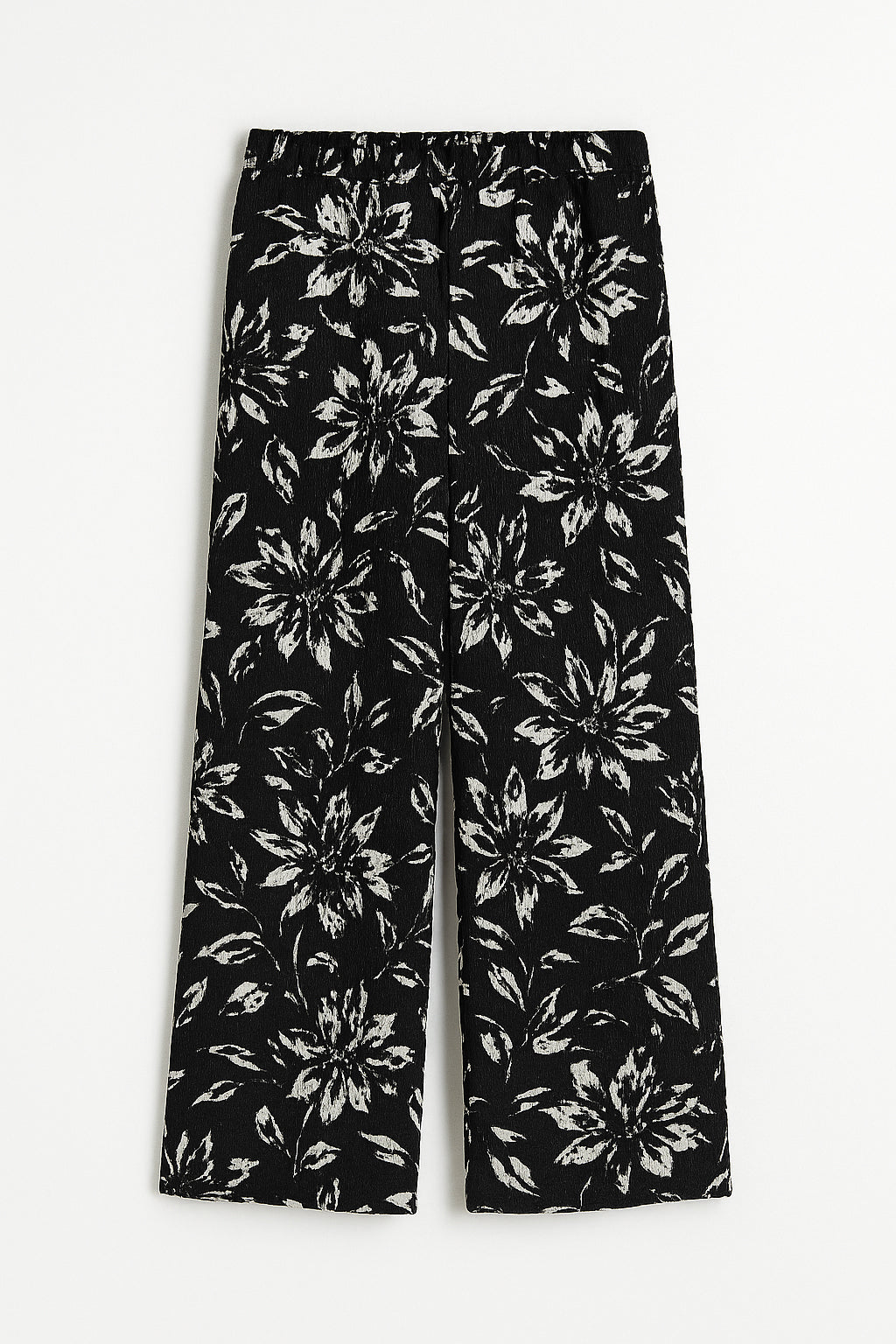 Black pants with white floral pattern on a white background