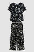 Black floral outfit with top and pants on a white background
