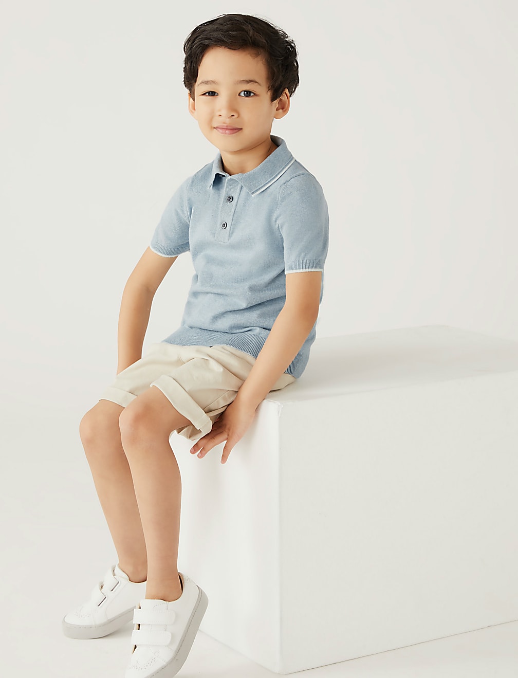 Light blue polo shirt with white collar on a light gray background