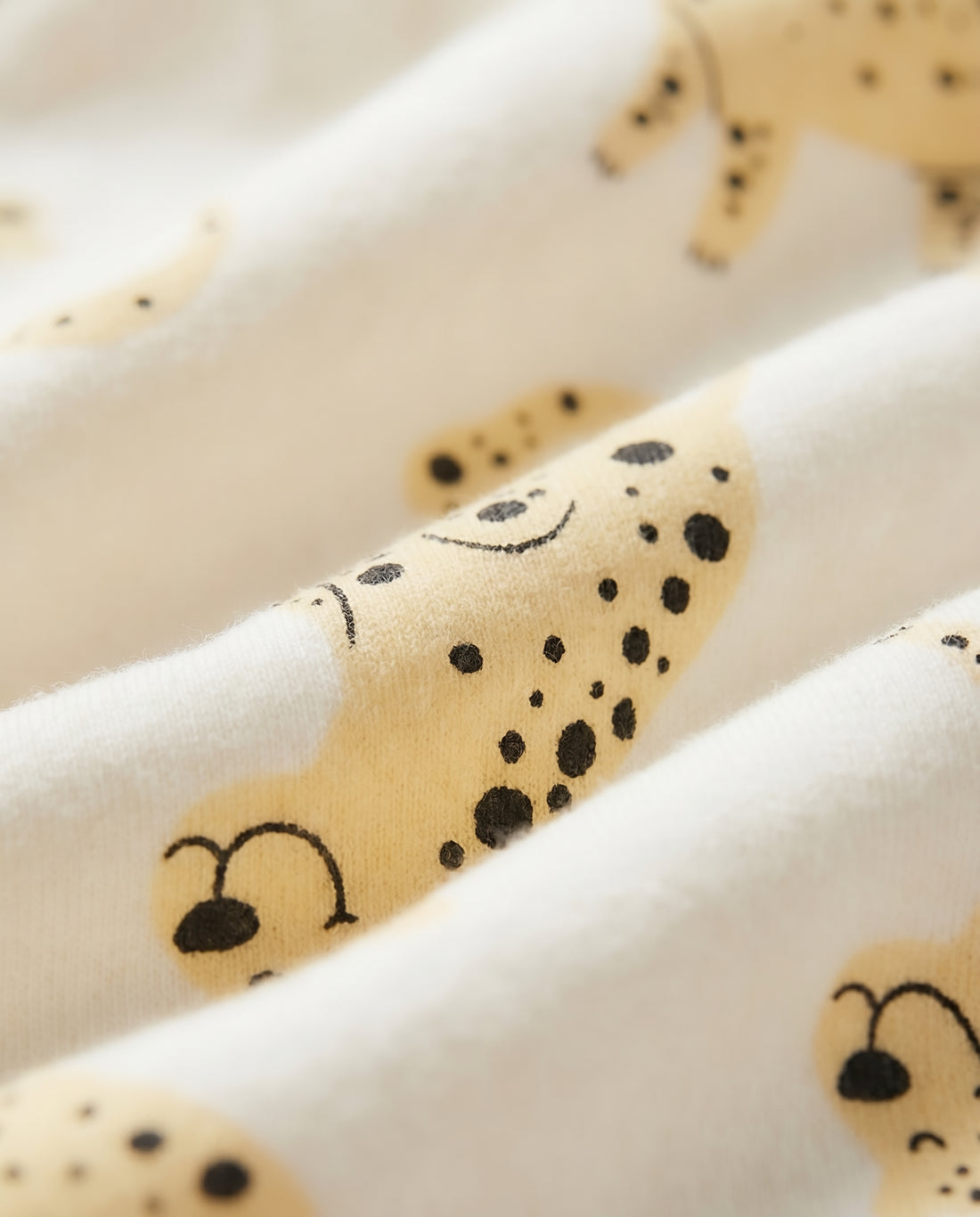 Baby cotton leggings in off-white with all-over yellow spotted animal print, elasticated waistband and ribbed ankle cuffs, flat lay view