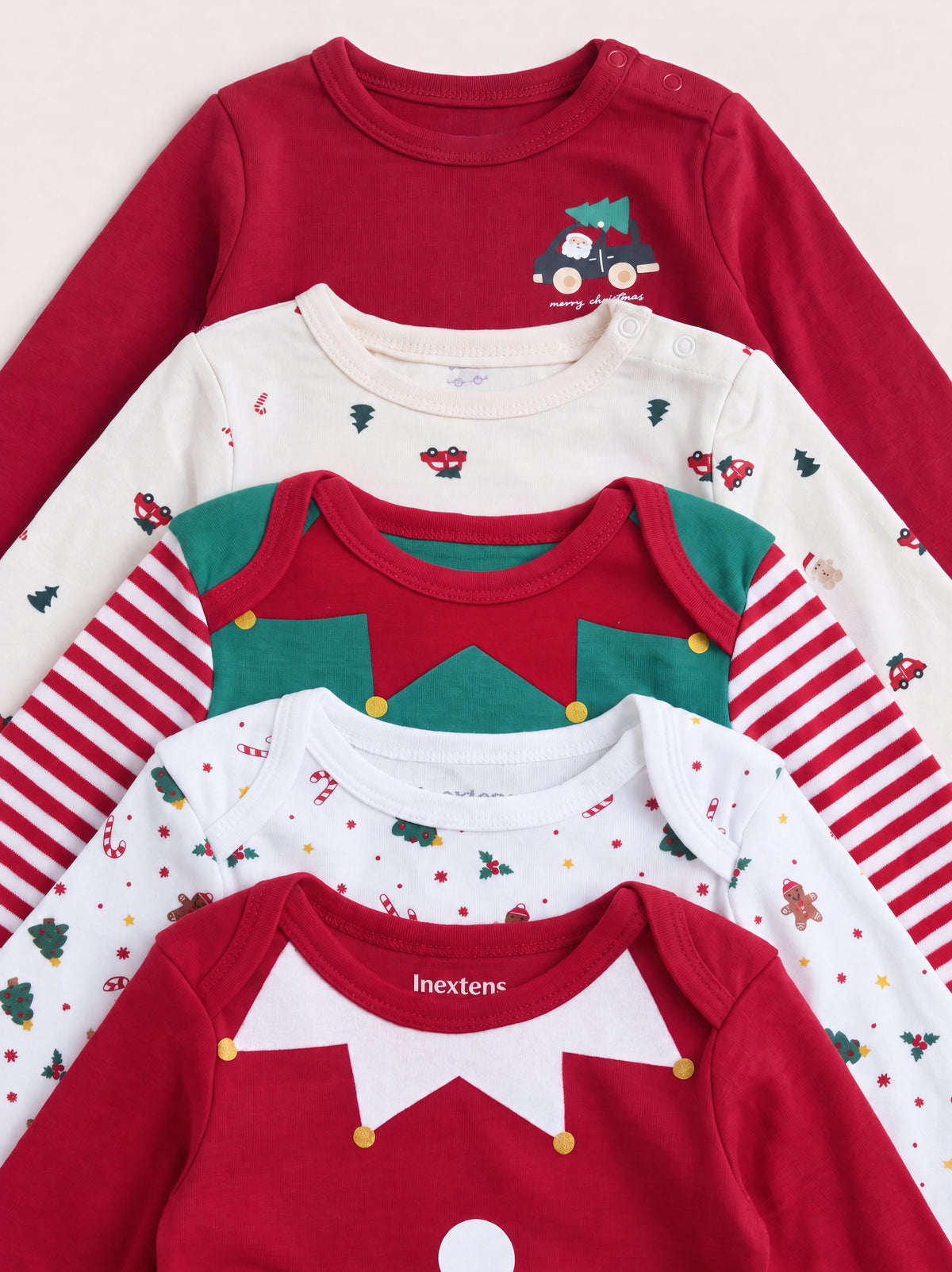 PTex Fashion 5-pack Christmas baby bodysuits stacked, showing envelope and popper shoulder necklines with festive prints