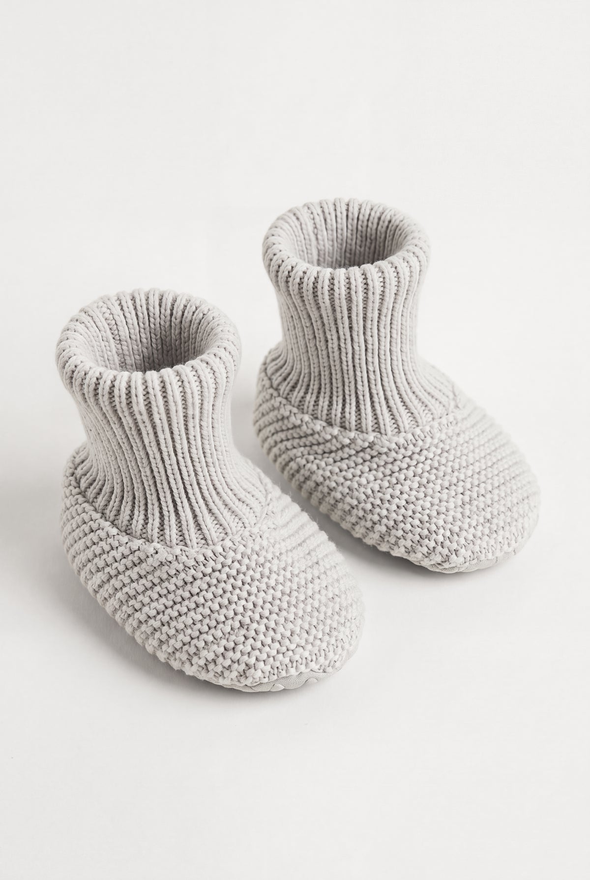 PTex Fashion light grey anti-slip knitted baby booties with ribbed cuff, pair shown at an angle