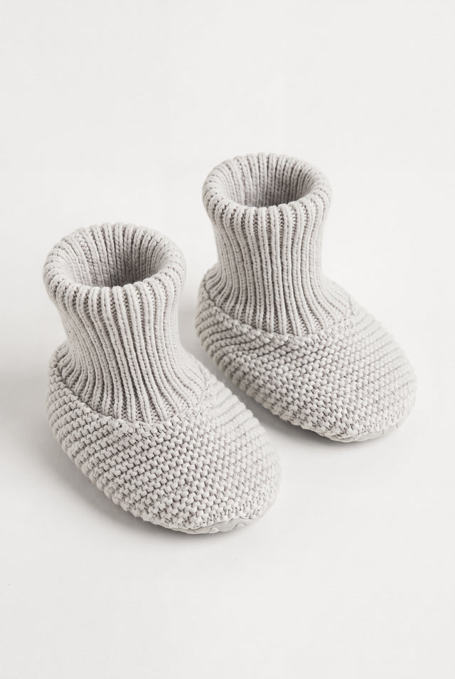 PTex Fashion light grey anti-slip knitted baby booties with ribbed cuff, pair shown at an angle