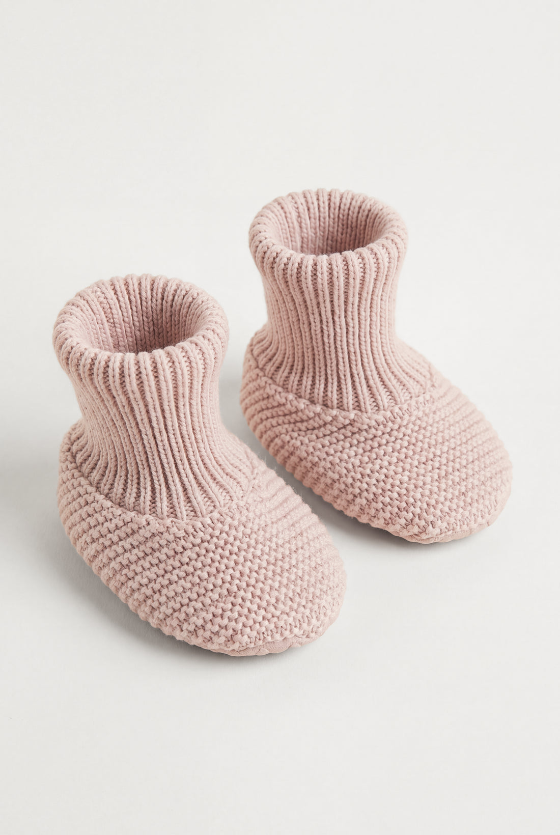 PTex Fashion dusty pink anti-slip knitted baby booties with ribbed cuff, pair shown at an angle