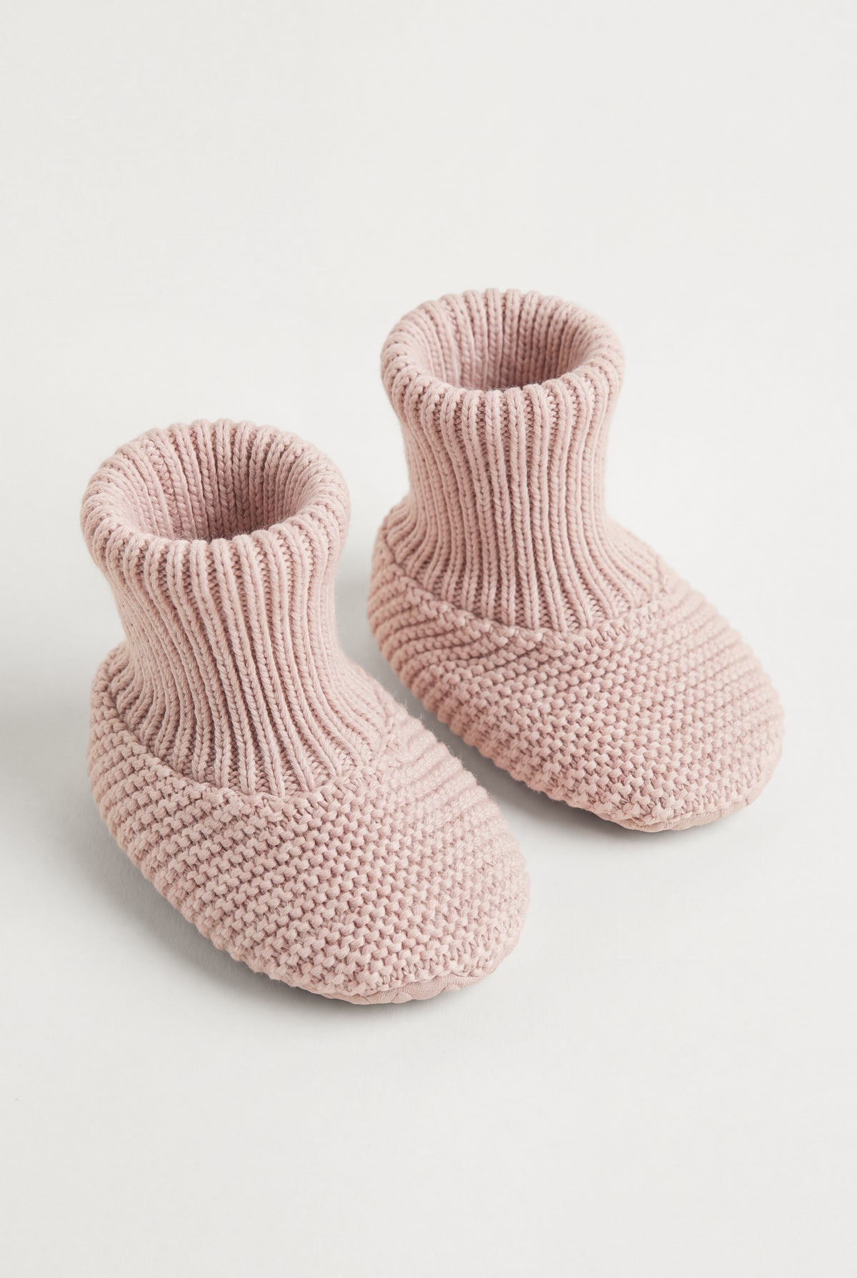 PTex Fashion dusty pink anti-slip knitted baby booties with ribbed cuff, pair shown at an angle