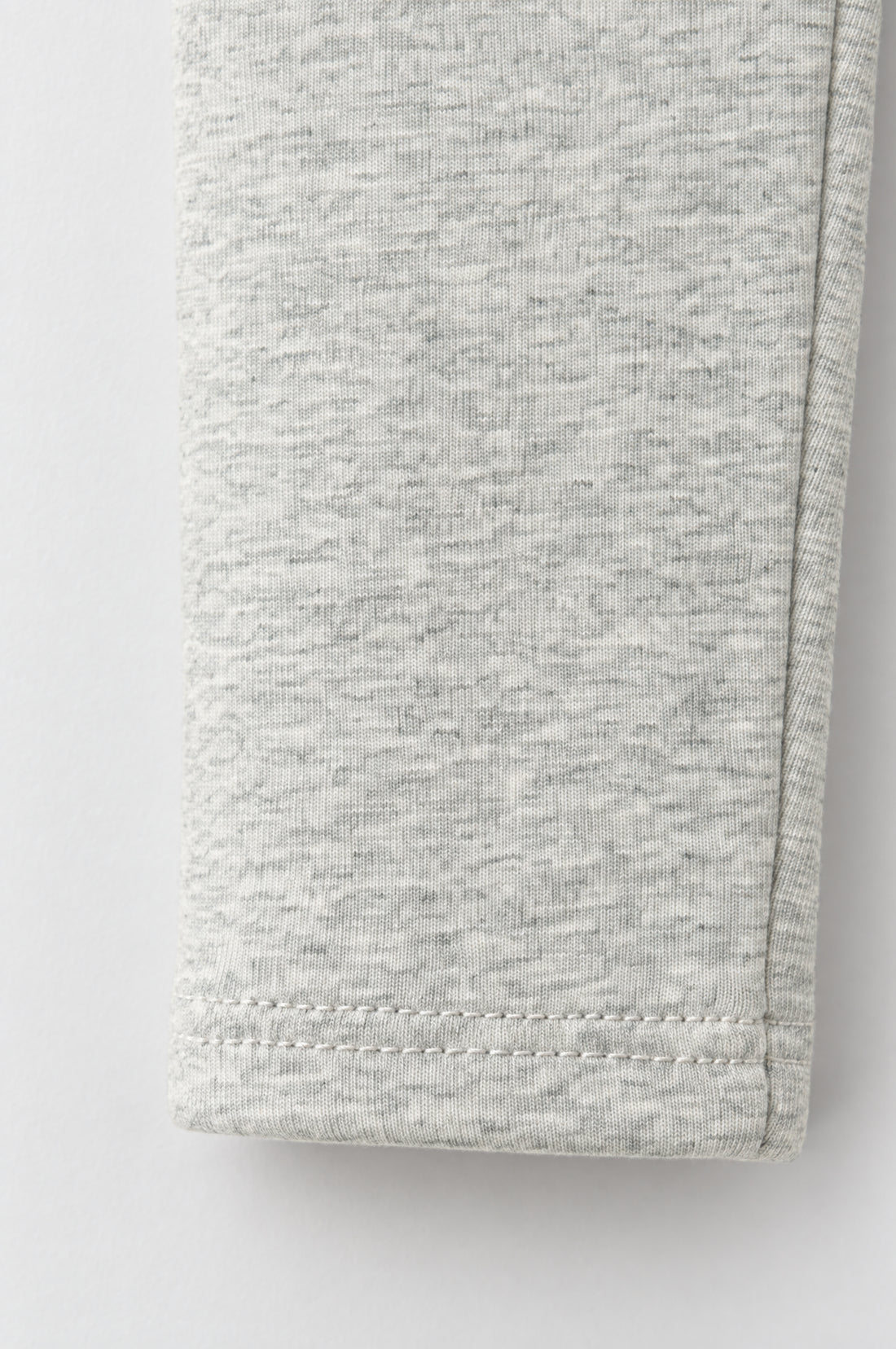 Baby girl light marl grey leggings with subtle heathered texture, elasticated waistband and neatly stitched leg hems.