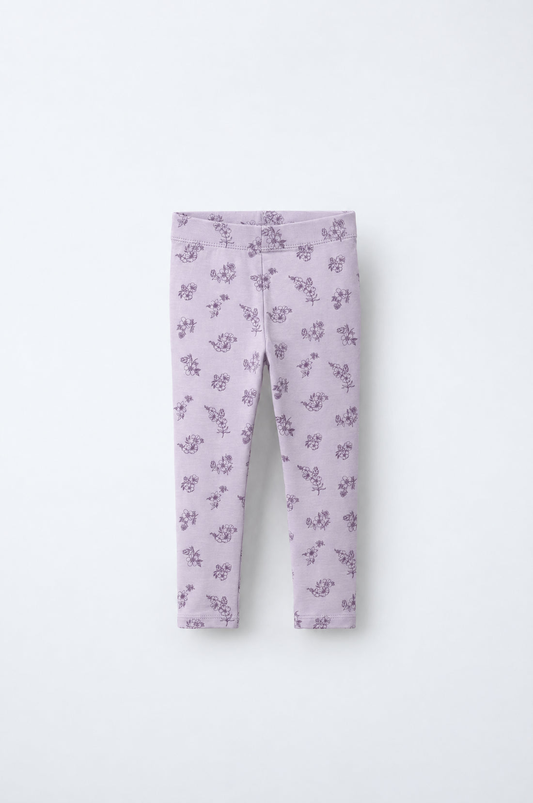 Baby girl lilac leggings with dark purple floral print, elastic waistband and double-stitched leg hems.