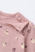 PTex Fashion pink floral ribbed baby bodysuit close-up showing shoulder press-stud opening and puff sleeve