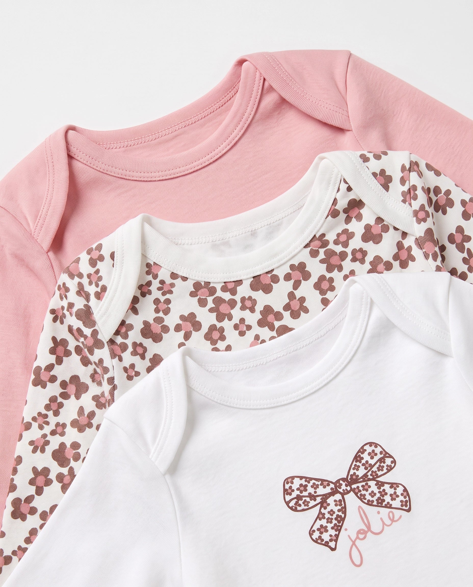 Close up of ribbed neckline on baby girls white, pink and floral full sleeve bodysuit 3 pack – PTex Fashion