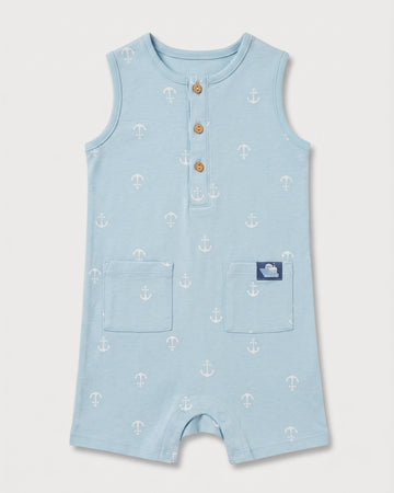 Full front view of baby boys' sleeveless blue anchor print romper with patch pockets and boat badge detail